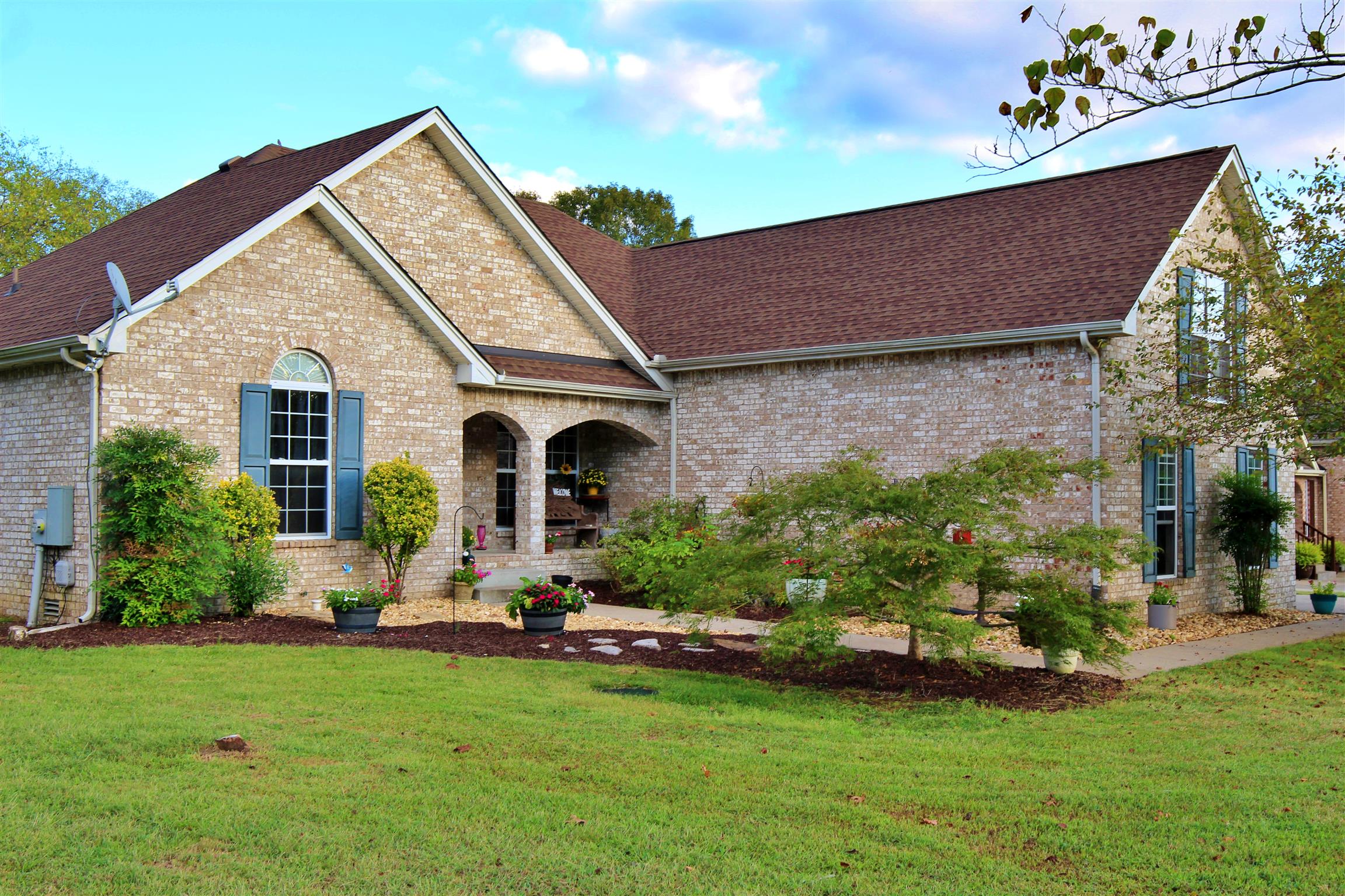 592 Windy Road Mount Juliet, TN 37122 - Photo 2 of 24 a front view of a house with a garden and plants