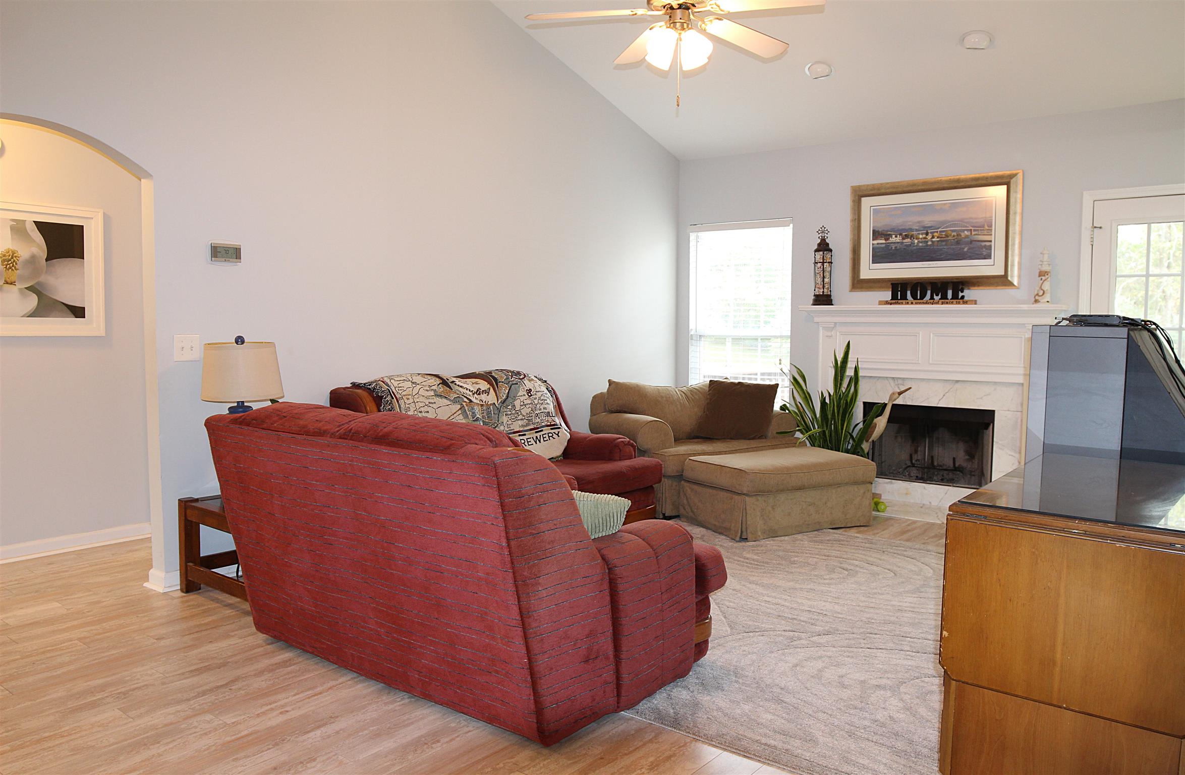 592 Windy Road Mount Juliet, TN 37122 - Photo 8 of 24 a living room with furniture a fireplace and a flat screen tv