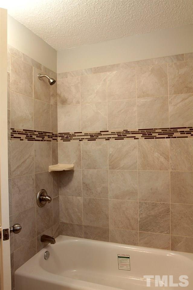 2000 Stoneglen Lane Raleigh, NC 27603 - Photo 22 of 25 a bathroom with a shower and a bathtub