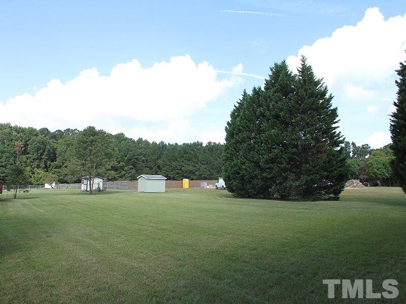 2000 Stoneglen Lane Raleigh, NC 27603 - Photo 24 of 25 a backyard of a house with lots of green space