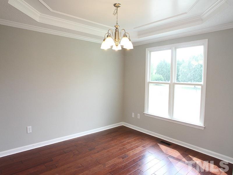 2000 Stoneglen Lane Raleigh, NC 27603 - Photo 6 of 25 a view of a room with wooden floor chandelier and window