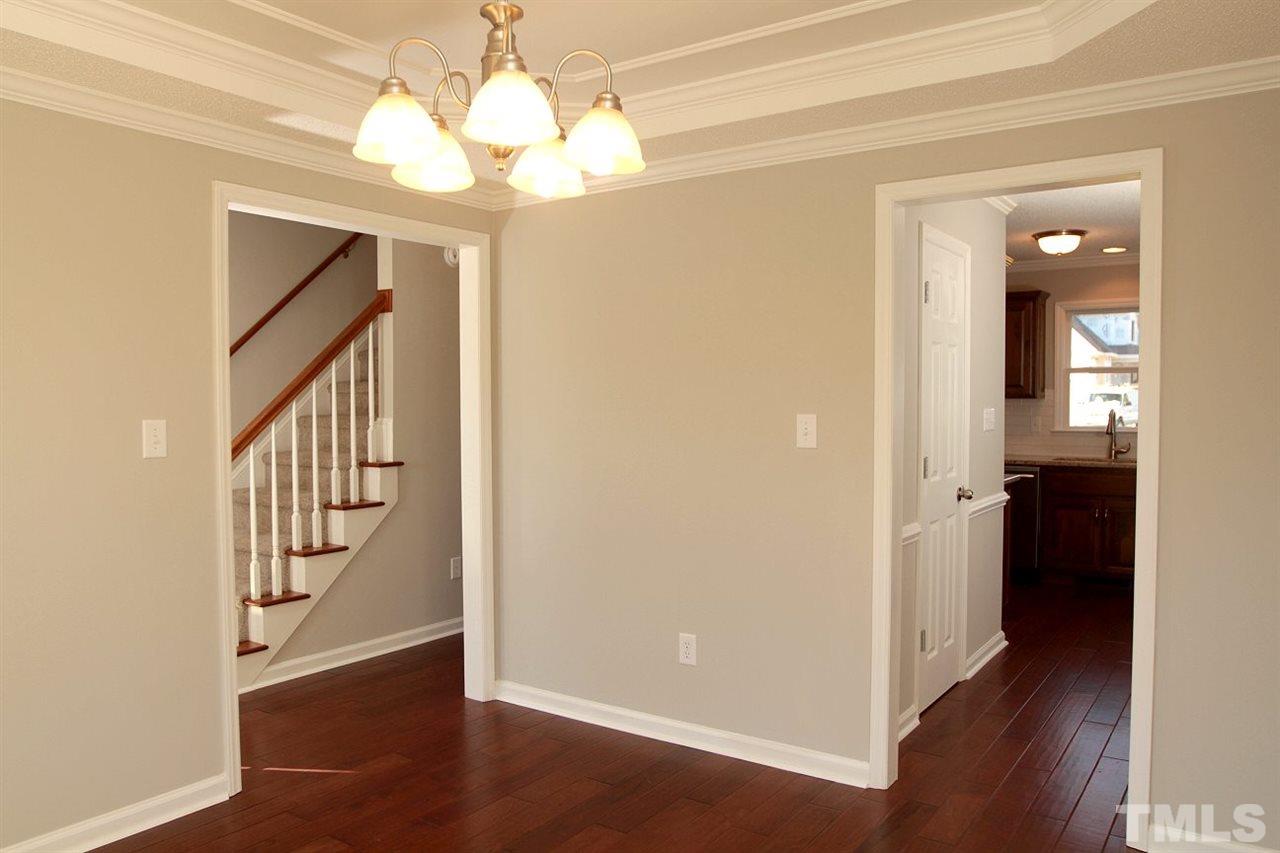 2000 Stoneglen Lane Raleigh, NC 27603 - Photo 7 of 25 a view of a hallway with wooden floor and staircase