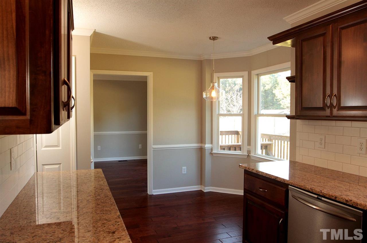 2000 Stoneglen Lane Raleigh, NC 27603 - Photo 8 of 25 a view of a kitchen with wooden floor and electronic appliances