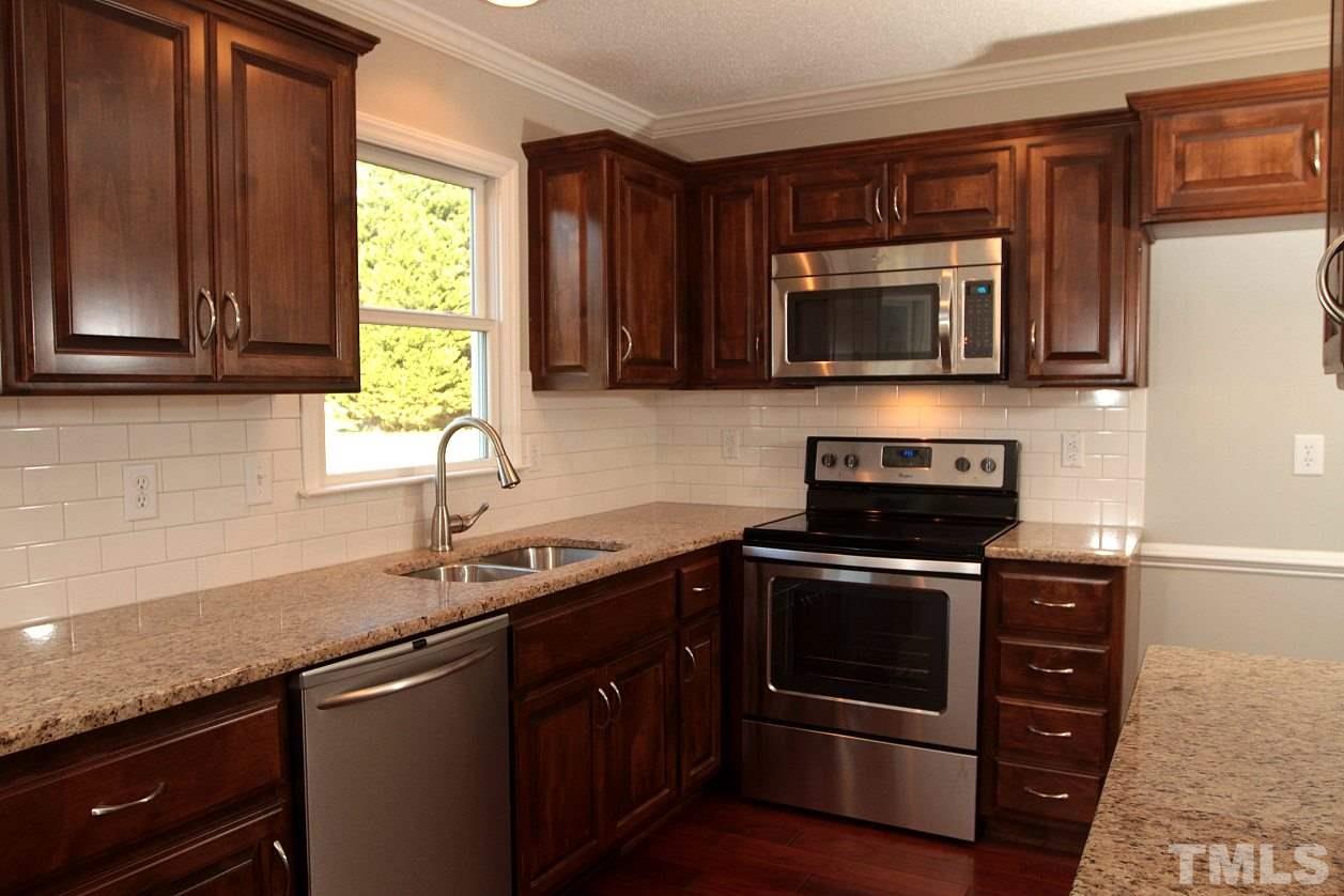 2000 Stoneglen Lane Raleigh, NC 27603 - Photo 9 of 25 a kitchen with stainless steel appliances granite countertop a sink and a microwave