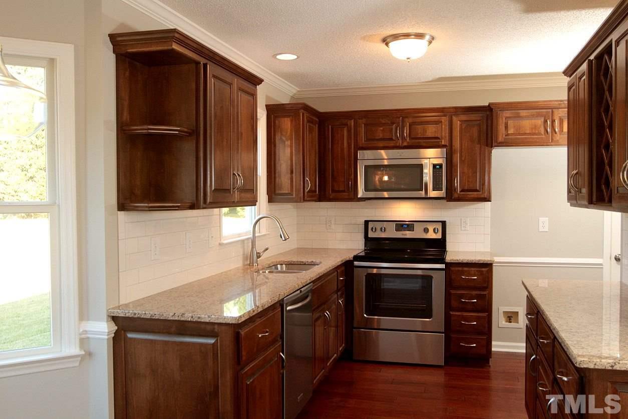 2000 Stoneglen Lane Raleigh, NC 27603 - Photo 10 of 25 a kitchen with stainless steel appliances granite countertop a stove and a refrigerator