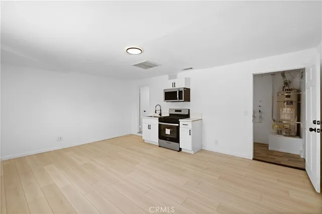 a kitchen with a sink and a stove top oven