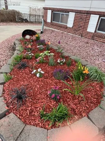 a front view of a house with a yard and a garden