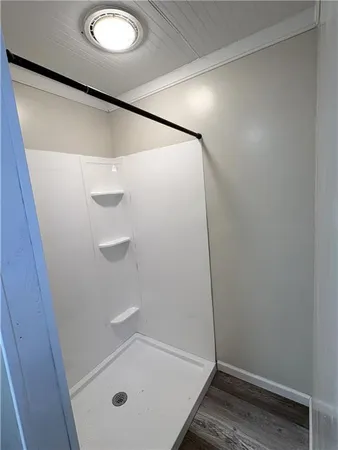 a bathroom with a glass shower door