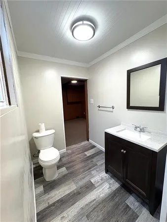 a bathroom with a toilet a sink and mirror