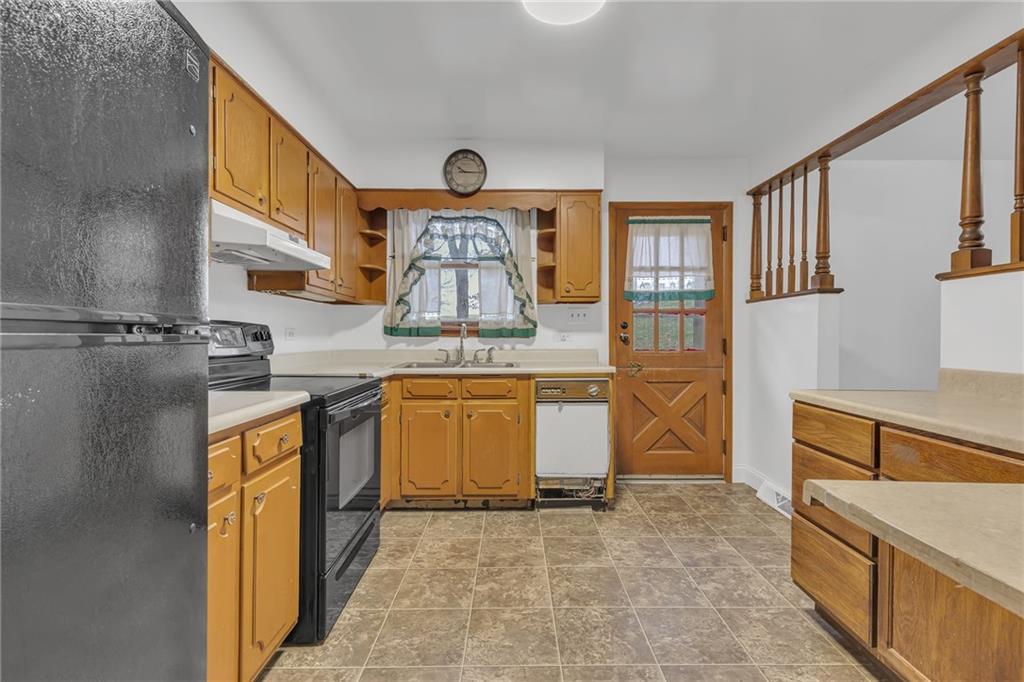 101 2nd Street Midland, PA 15059 - Photo 6 of 37 a kitchen with stainless steel appliances granite countertop a stove a sink and a refrigerator