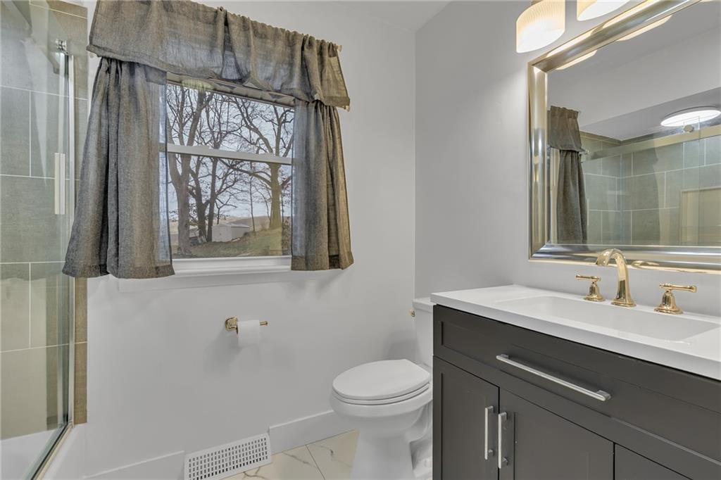 101 2nd Street Midland, PA 15059 - Photo 8 of 37 a bathroom with a sink a toilet a mirror and window