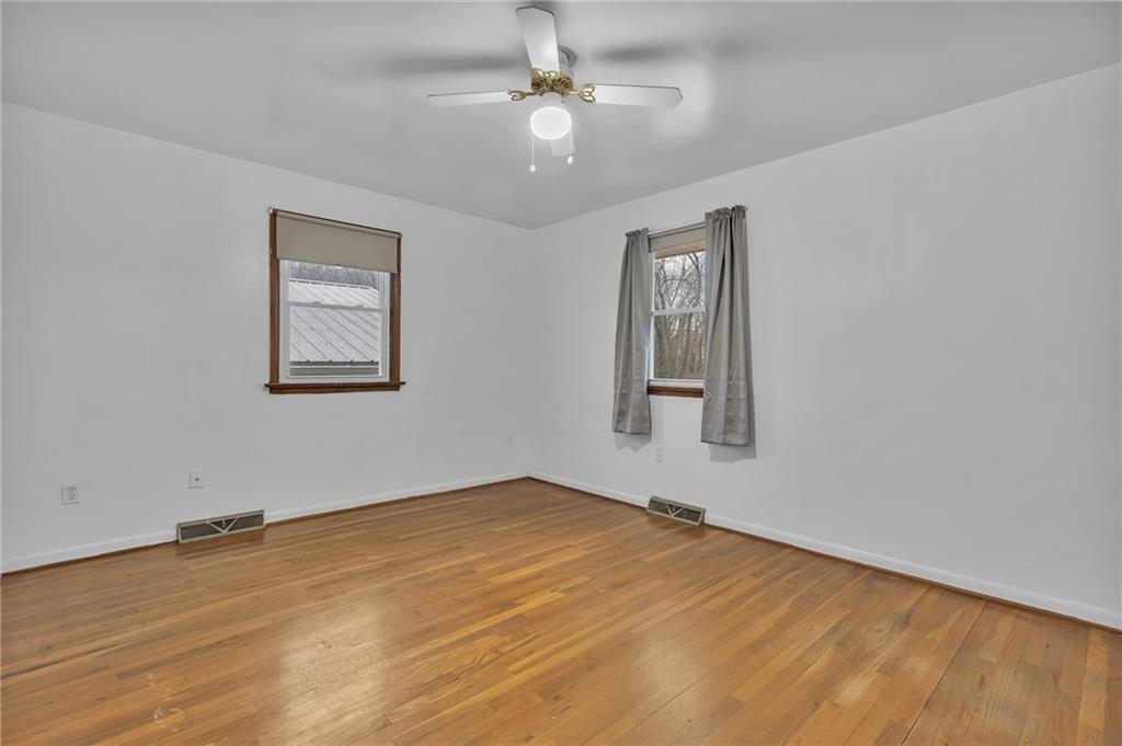 101 2nd Street Midland, PA 15059 - Photo 10 of 37 a view of an empty room with window and wooden floor