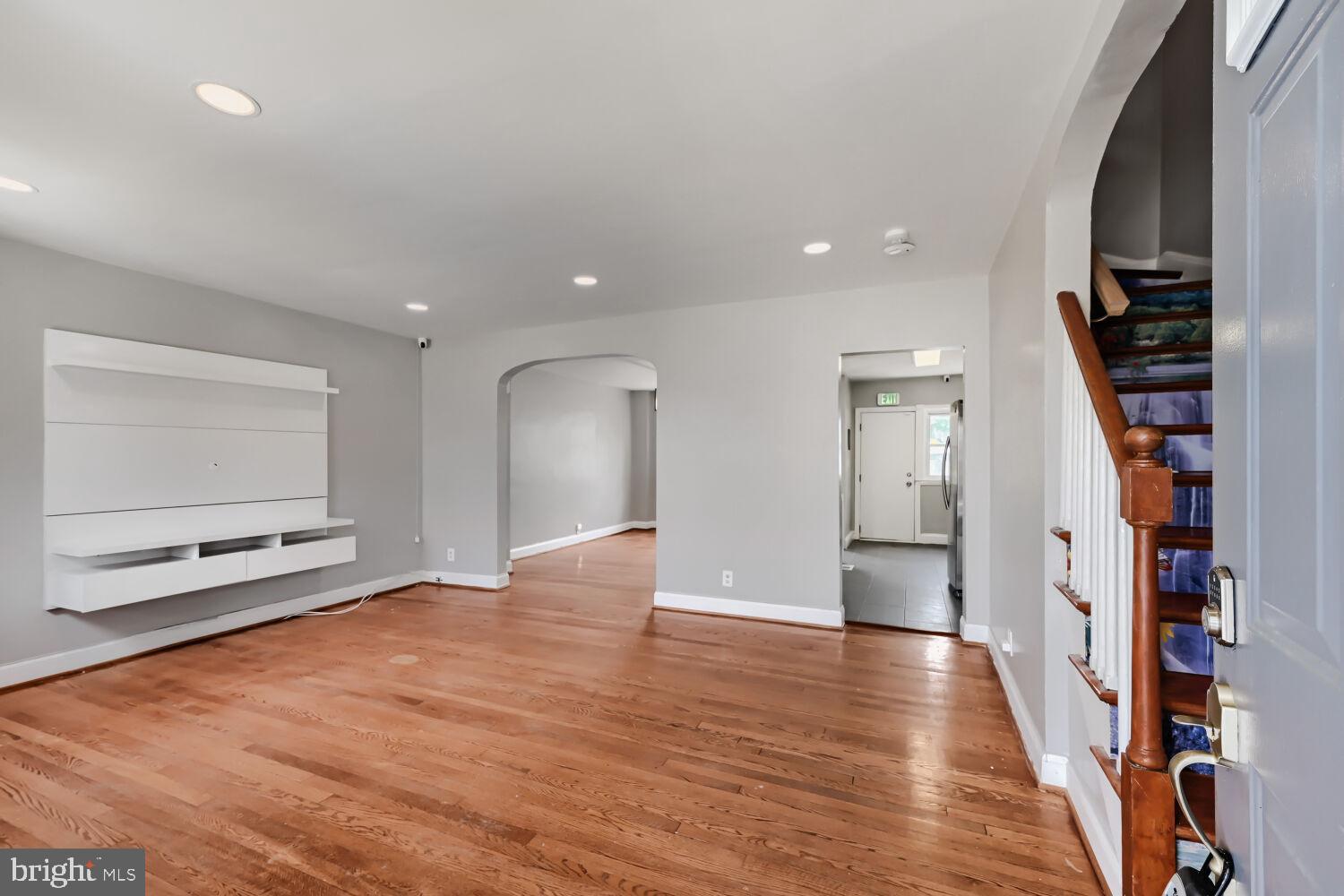 1014 Lyndhurst Street Baltimore, MD 21229 - Photo 7 of 29 a view of an empty room with wooden floor and entryway