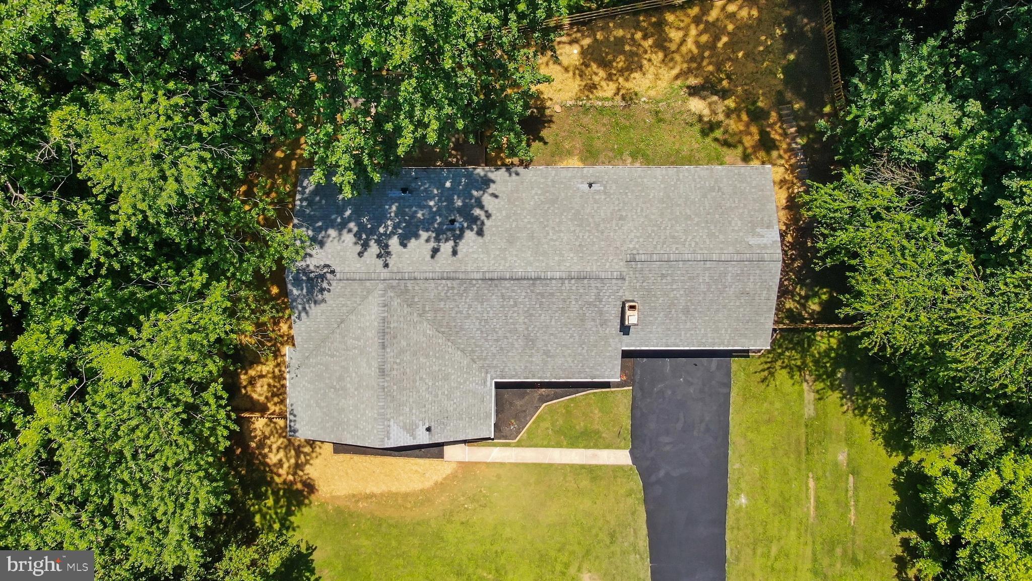 1013 Roxleigh Road Baltimore, MD 21286 - Photo 51 of 57 an aerial view of a house with swimming pool and large trees