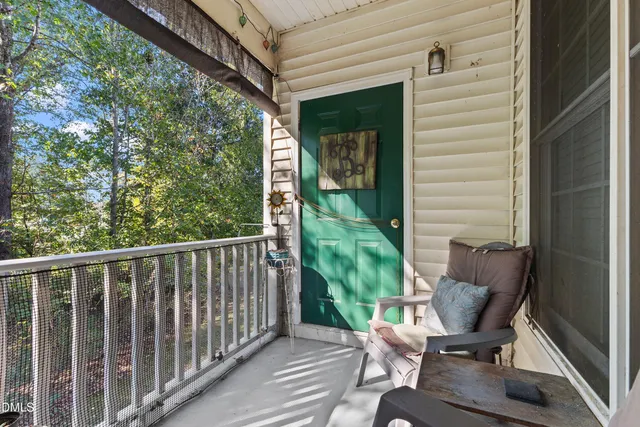 a view of a chair and table in the balcony