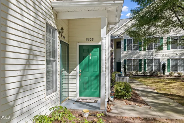 a front view of a building with a garden
