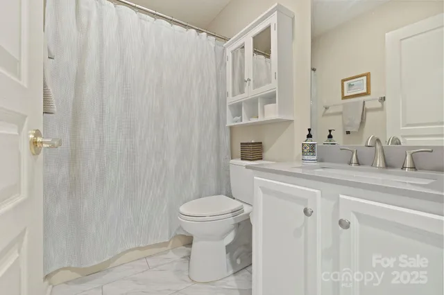 a living room with furniture and a book shelf