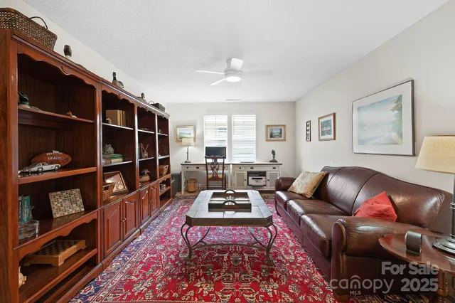 a living room with furniture and a book shelf