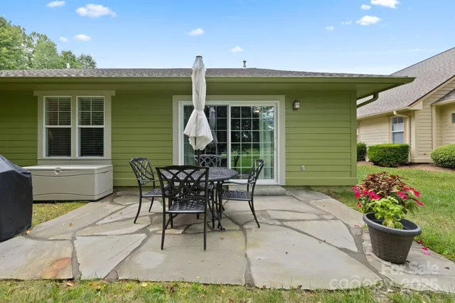 a view of a backyard with a table and chairs