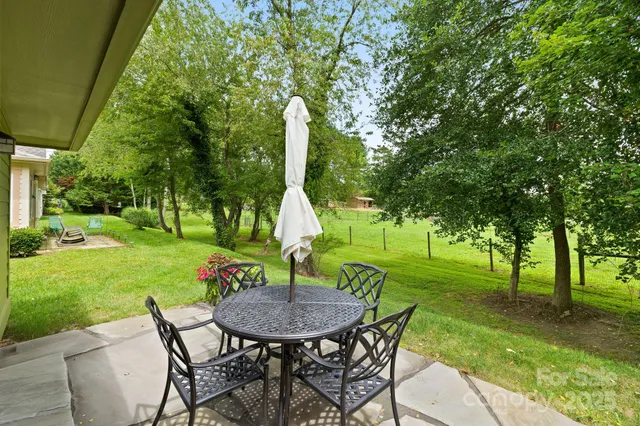 an aerial view of a house with swimming pool garden and patio