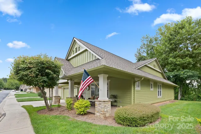 a aerial view of a house with a yard and large tree
