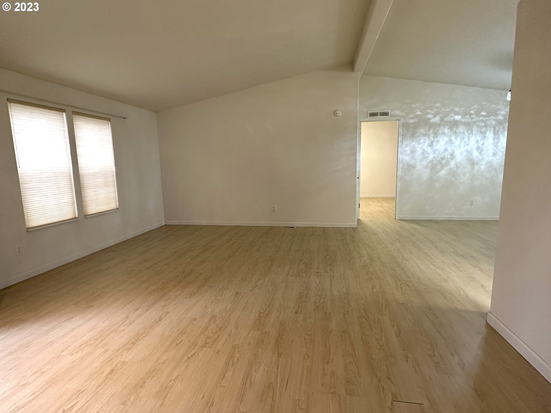4055 Royal Avenue, Unit 24 Eugene, OR 97402 - Photo 11 of 31 an empty room with wooden floor and windows