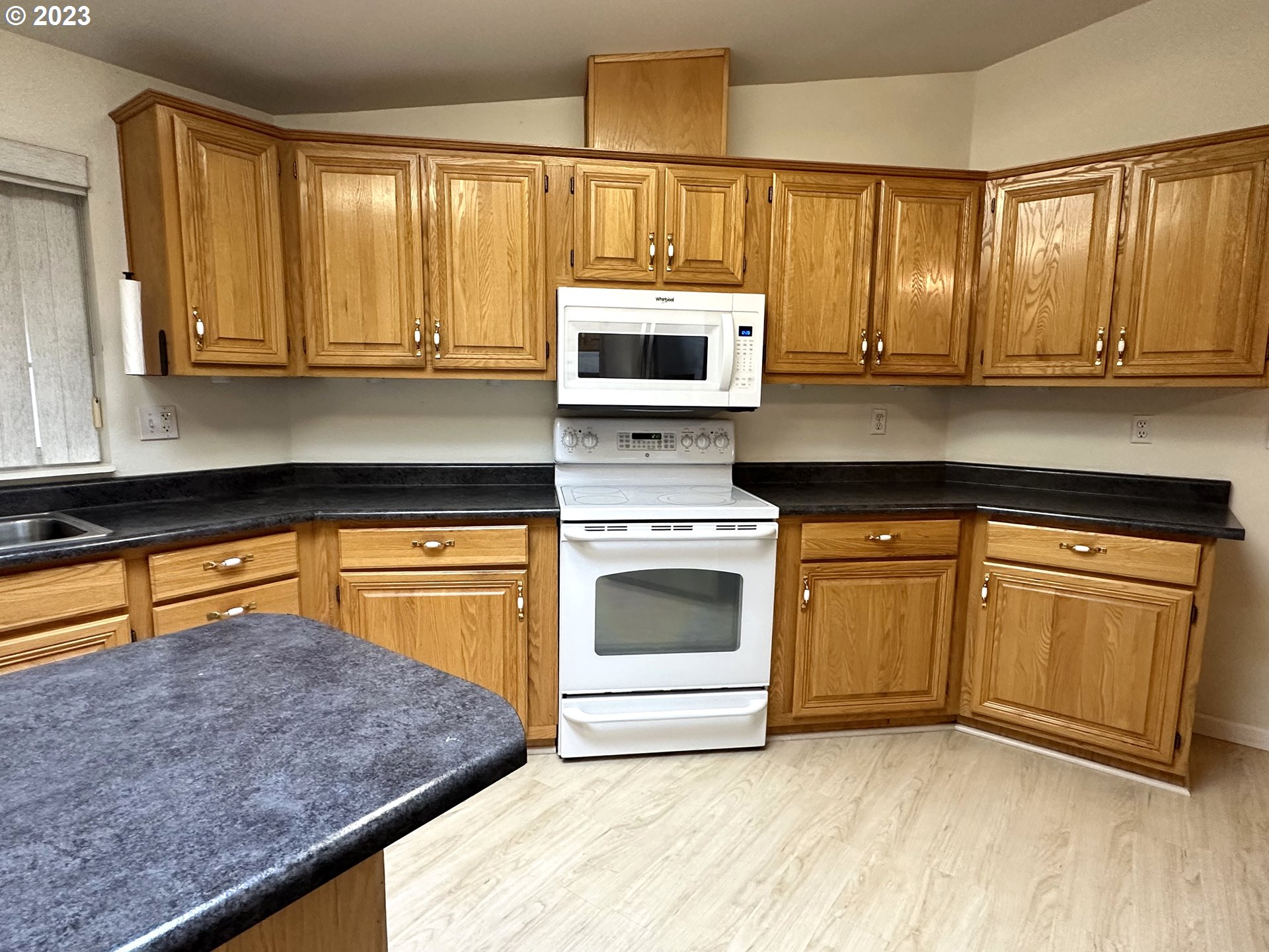 4055 Royal Avenue, Unit 24 Eugene, OR 97402 - Photo 4 of 31 a kitchen with stainless steel appliances granite countertop a stove a sink and a microwave