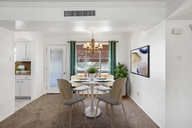a dining room with furniture and window