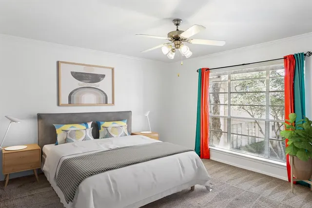 a bedroom with a large bed and a window