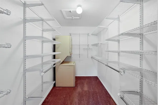 a kitchen with cabinets and wooden floor