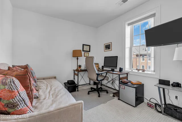 a view of a livingroom with workspace and a couch