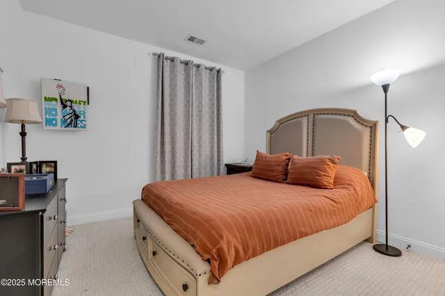 a bedroom with a bed and a mirror