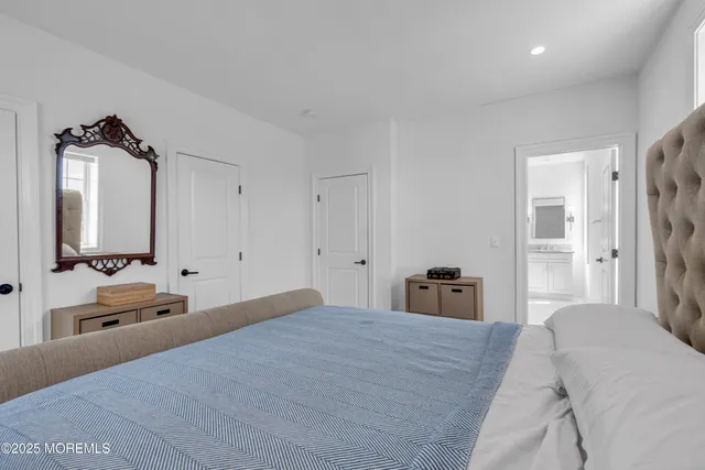 a bedroom with a bed and a large mirror