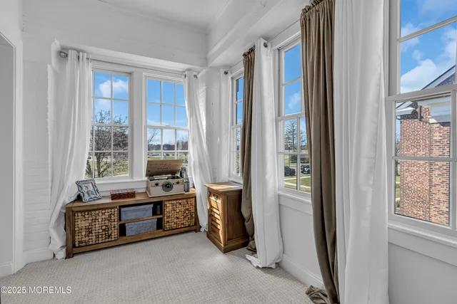 a spacious bedroom with a bed and a window