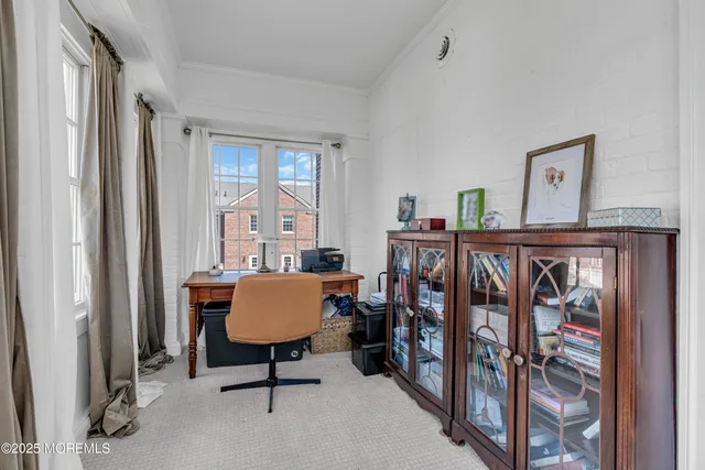 a view of a bedroom with furniture window and wooden floor