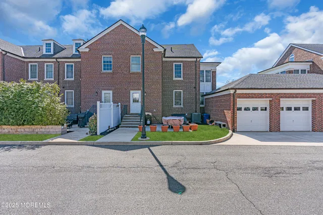 a front view of a house with a yard and a garage
