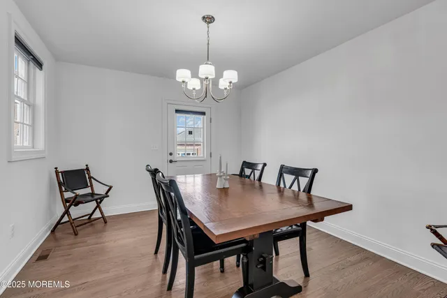 a view of a dining room with a table and chairs