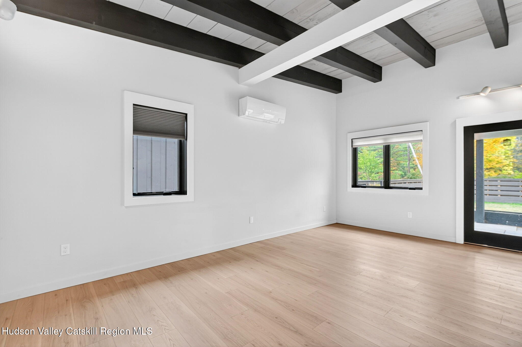 420 Wittenberg Road Mount Tremper, NY 12457 - Photo 14 of 24 an empty room with wooden floor and windows