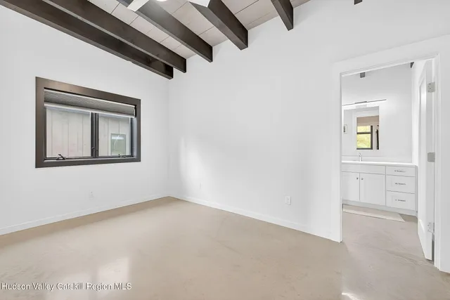 an empty room with windows and closet