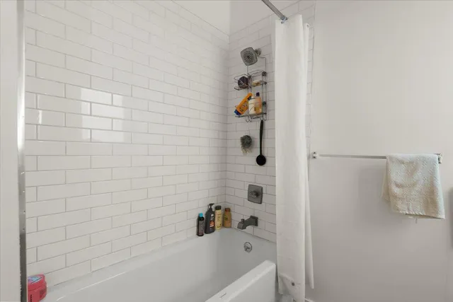 a bathroom with a bathtub and a shower