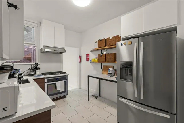 a kitchen with stainless steel appliances a refrigerator sink and stove