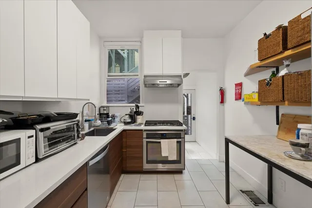 a kitchen with stainless steel appliances granite countertop a stove and a sink