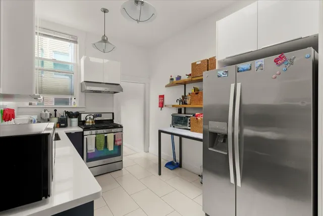 a kitchen with stainless steel appliances a refrigerator sink and stove