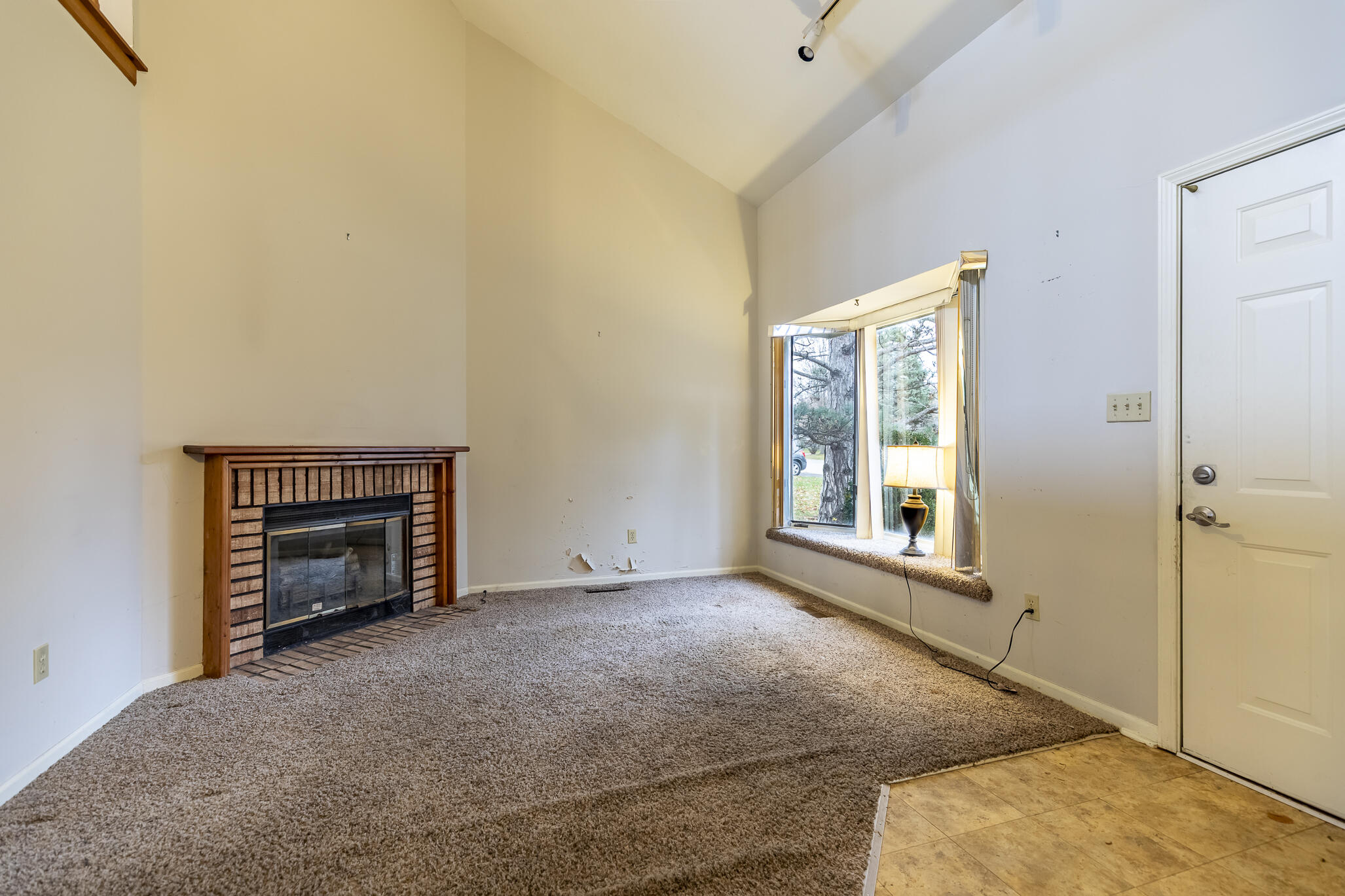 1874 Springvale Drive Crown Point, IN 46307 - Photo 5 of 26 a view of an empty room with a window and fireplace