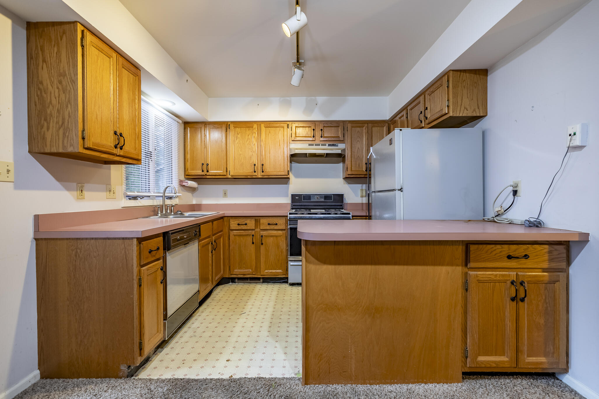 1874 Springvale Drive Crown Point, IN 46307 - Photo 10 of 26 a kitchen with stainless steel appliances granite countertop a sink a stove and a refrigerator