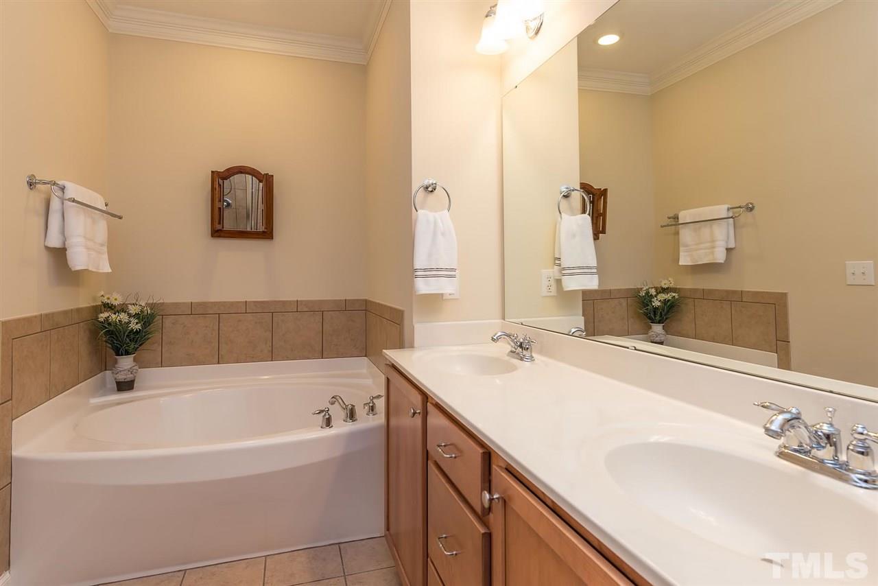 650 Democracy Street Raleigh, NC 27603 - Photo 14 of 25 a bathroom with a bathtub and a sink