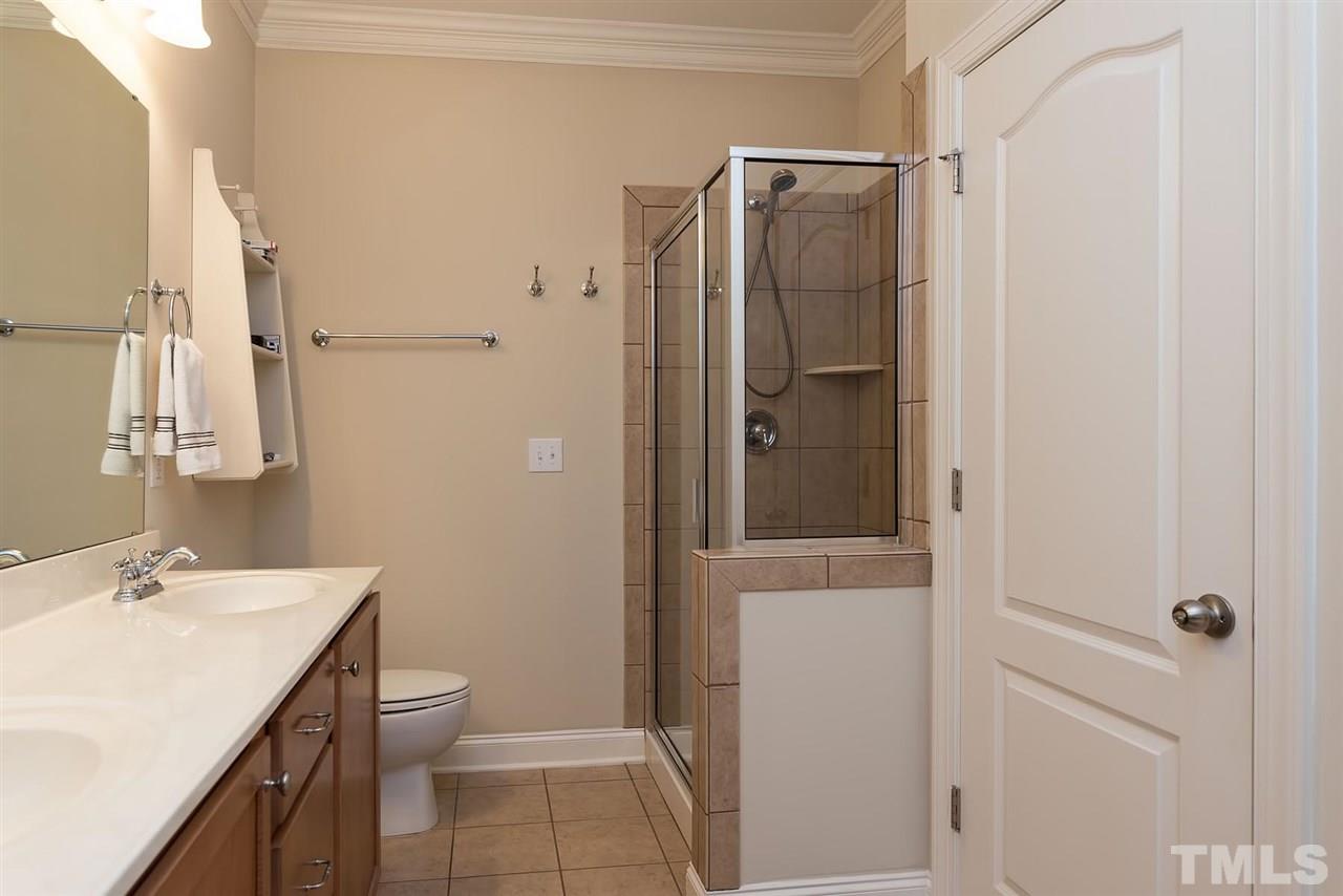 650 Democracy Street Raleigh, NC 27603 - Photo 15 of 25 a bathroom with a granite countertop sink toilet and shower