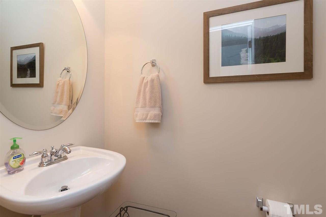 650 Democracy Street Raleigh, NC 27603 - Photo 16 of 25 a bathroom with a sink and mirror