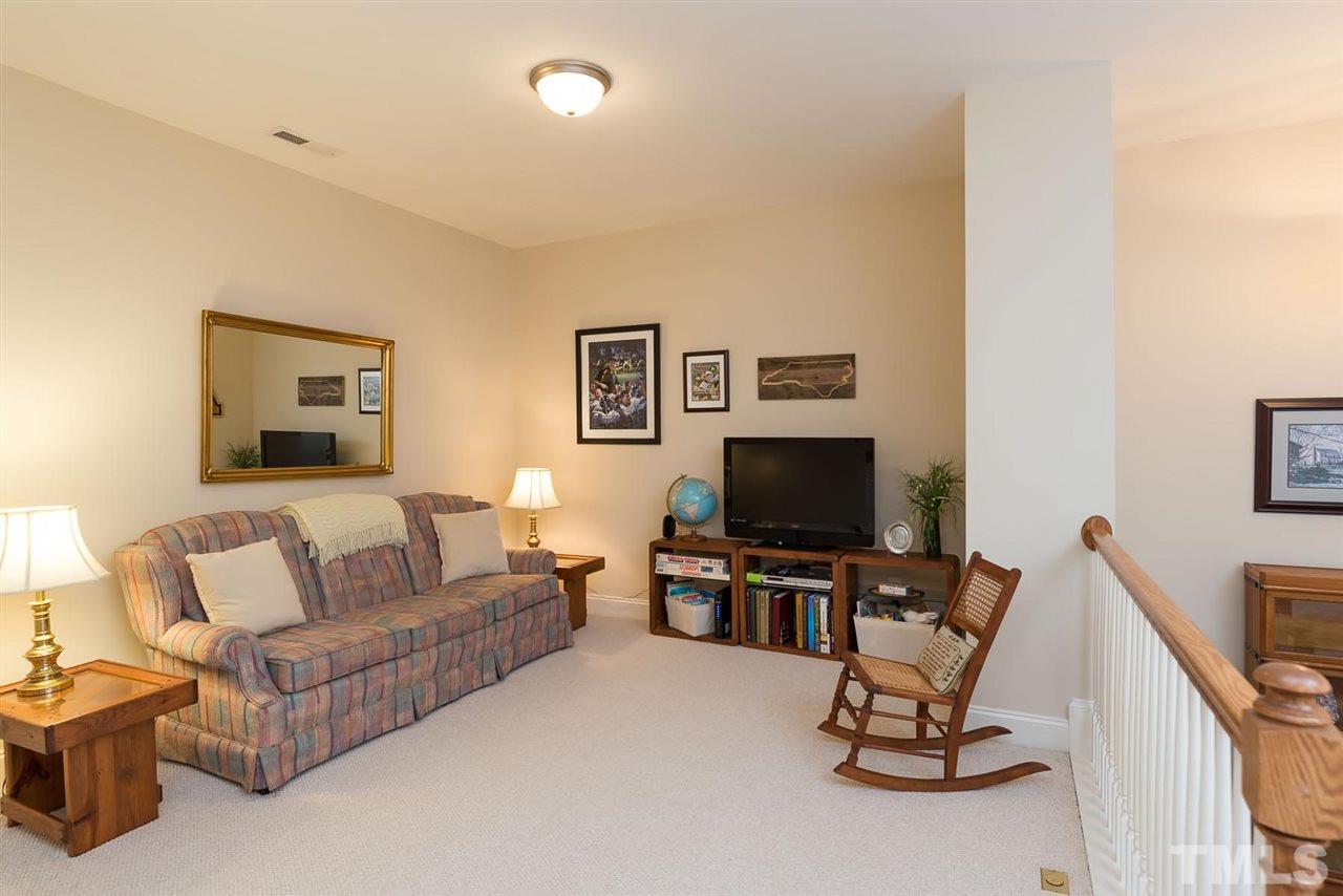 650 Democracy Street Raleigh, NC 27603 - Photo 17 of 25 a living room with furniture and a flat screen tv