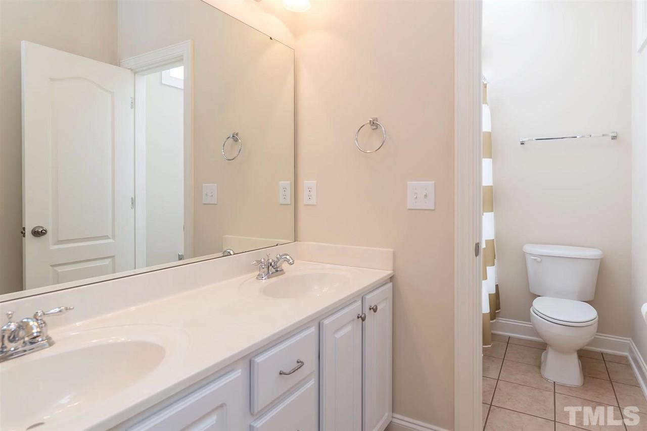 650 Democracy Street Raleigh, NC 27603 - Photo 21 of 25 a bathroom with a sink a toilet and shower